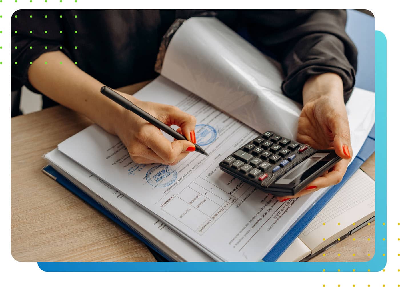 A person writing in a book, while holding a calculator