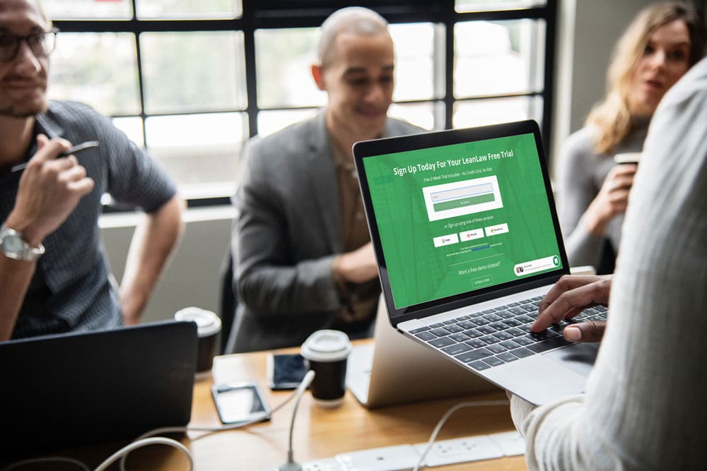 LeanLaw Person holding open laptop with LeanLaw Free Trial page