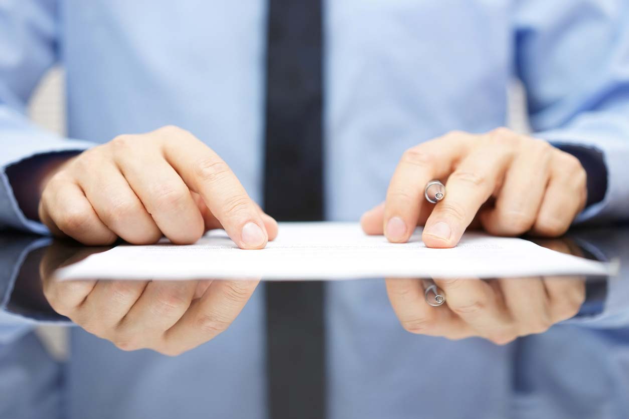 A man with his fingers on a legal invoice template.