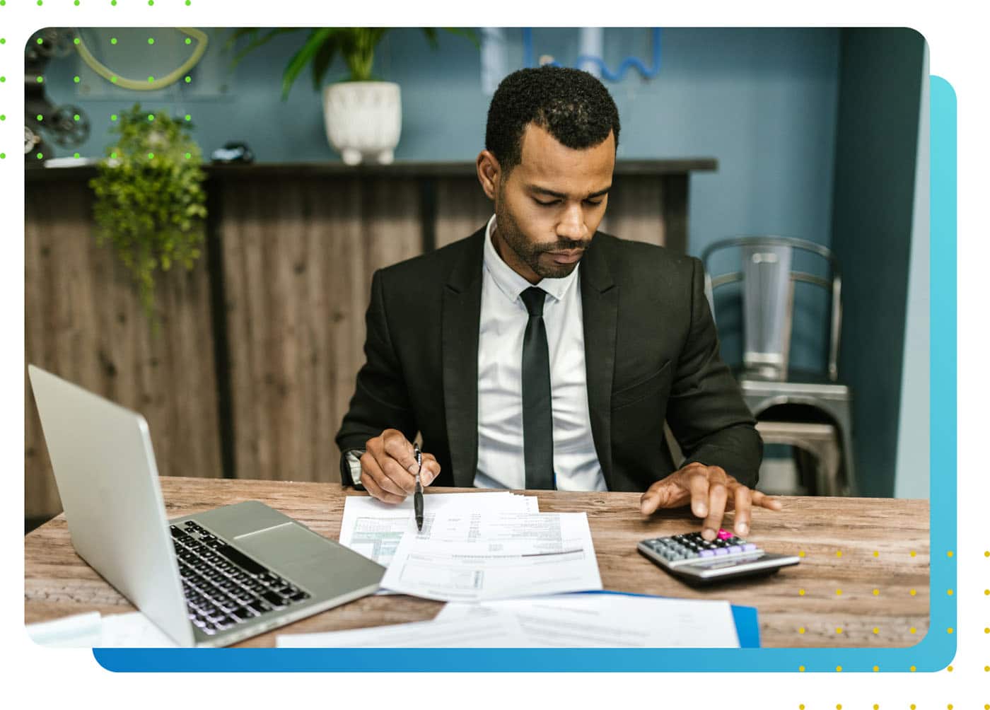 Man in suit working and pressing a calculator