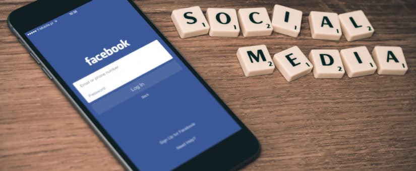 LeanLaw Facebook login on smartphone screen next to blocks spelling SOCIAL MEDIA