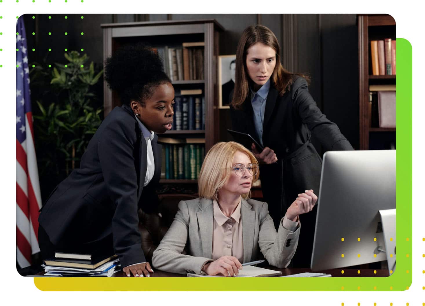 Three female lawyers staring at a computer screen