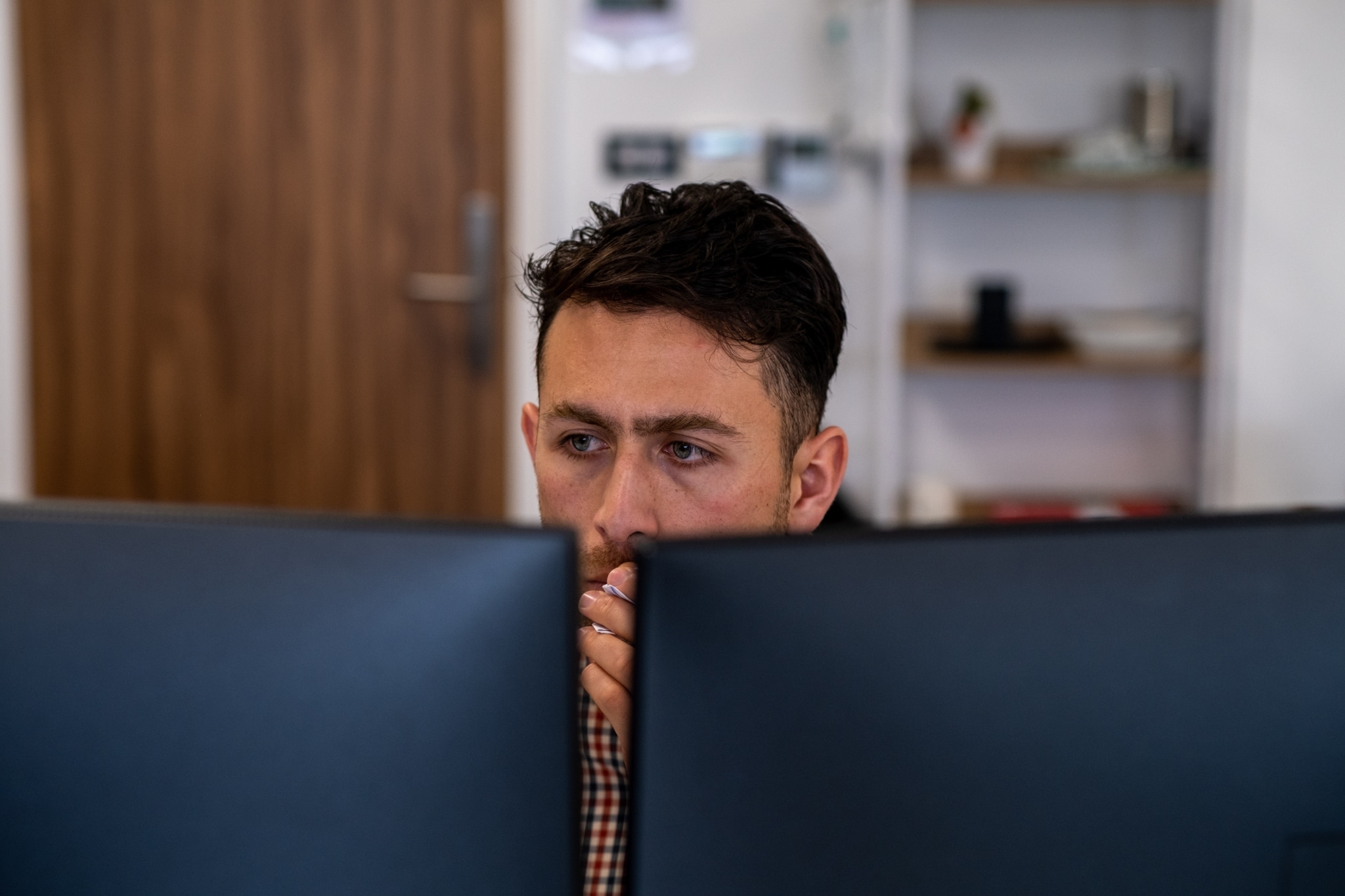 Working Man Staring at Computer Screens