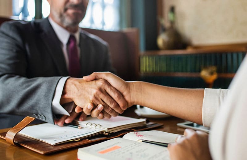 LeanLaw Lawyer shaking hands with client across desk