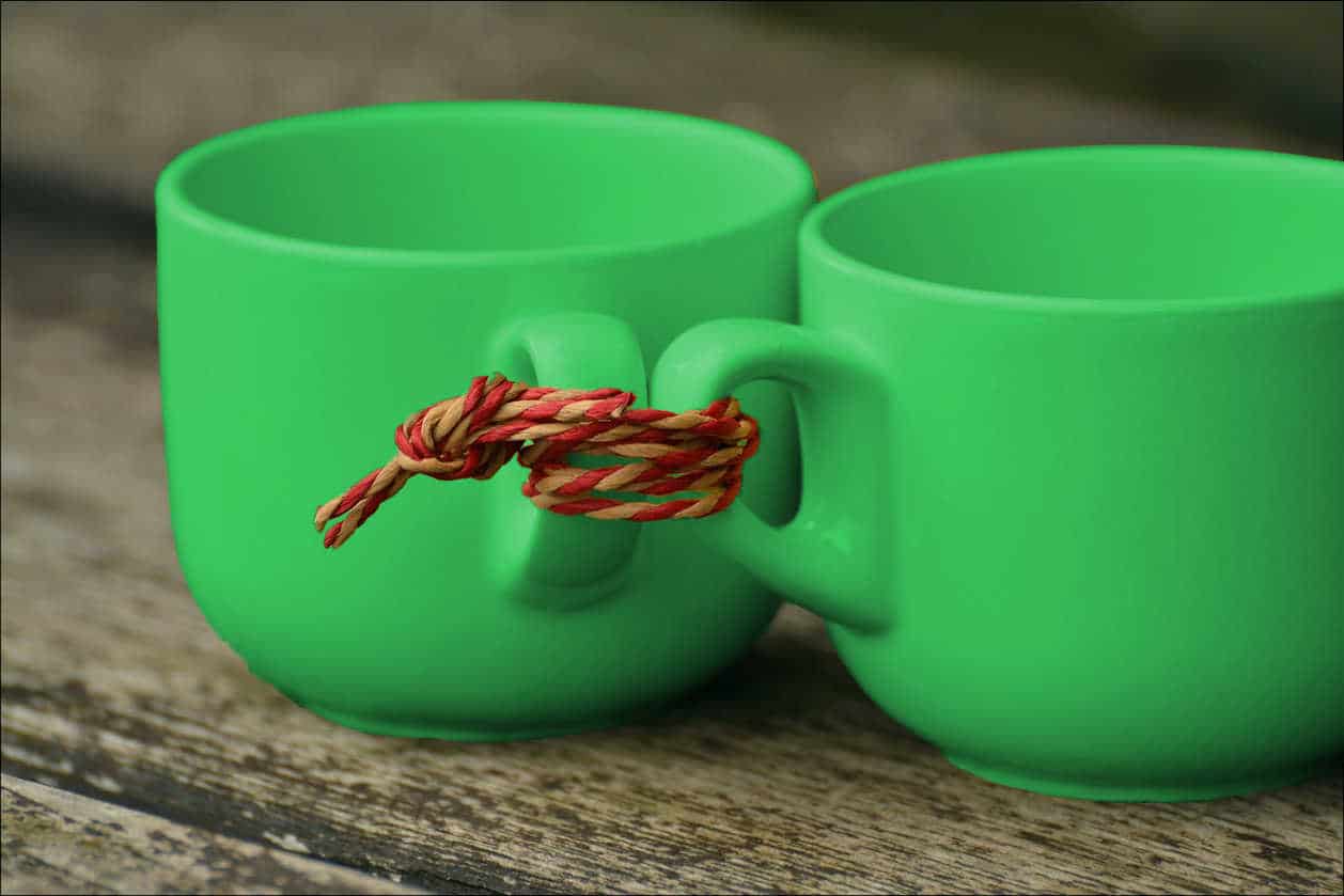 LeanLaw Red and yellow string tying together two mug handles